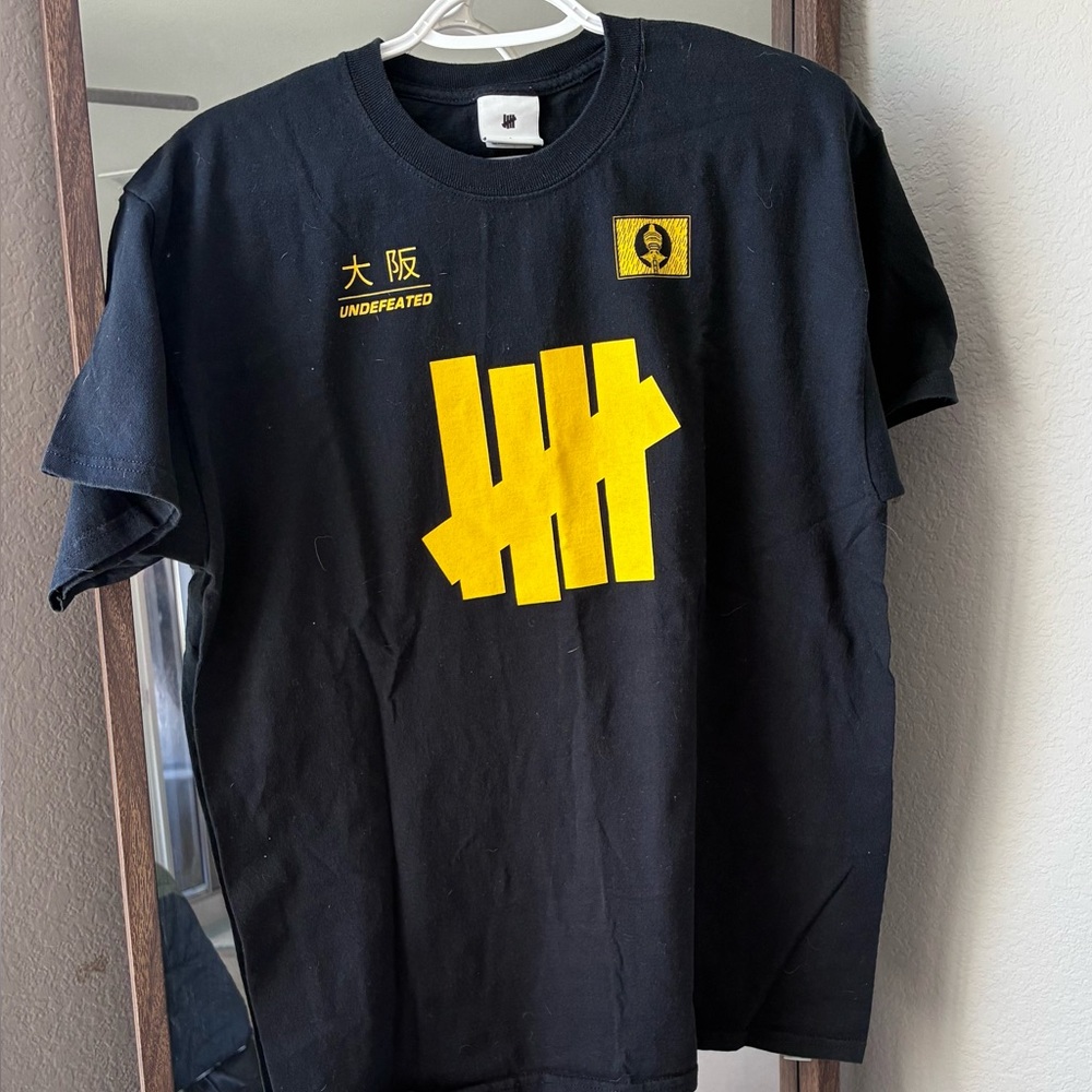 UNDEFEATED Black T-Shirt with Yellow Graphic